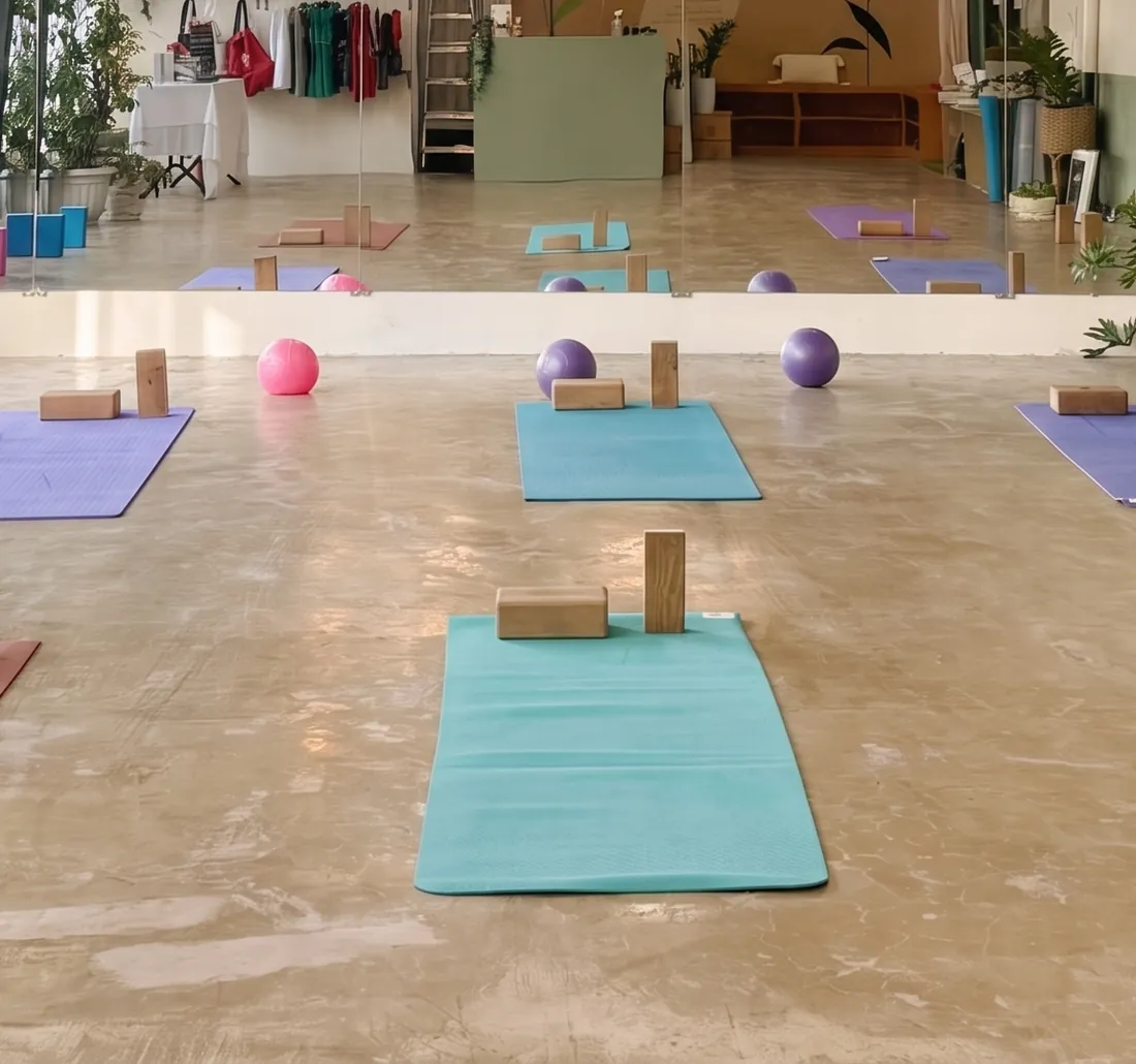Mats, blocks and balls laid out on the floor of the Love Yoga Magnum studio